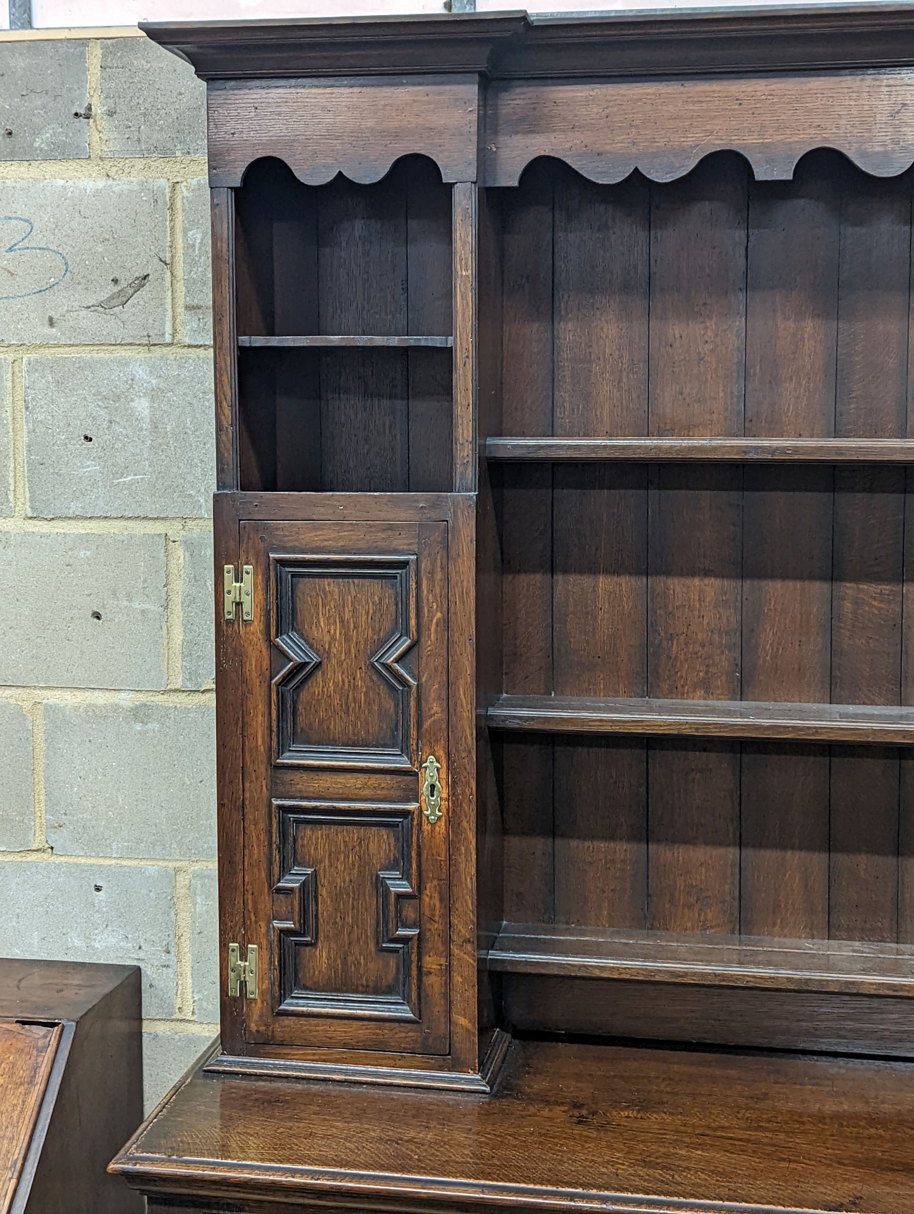 An early 20th century Jacobean revival oak dresser, width 168cm, depth 48cm, height 218cm